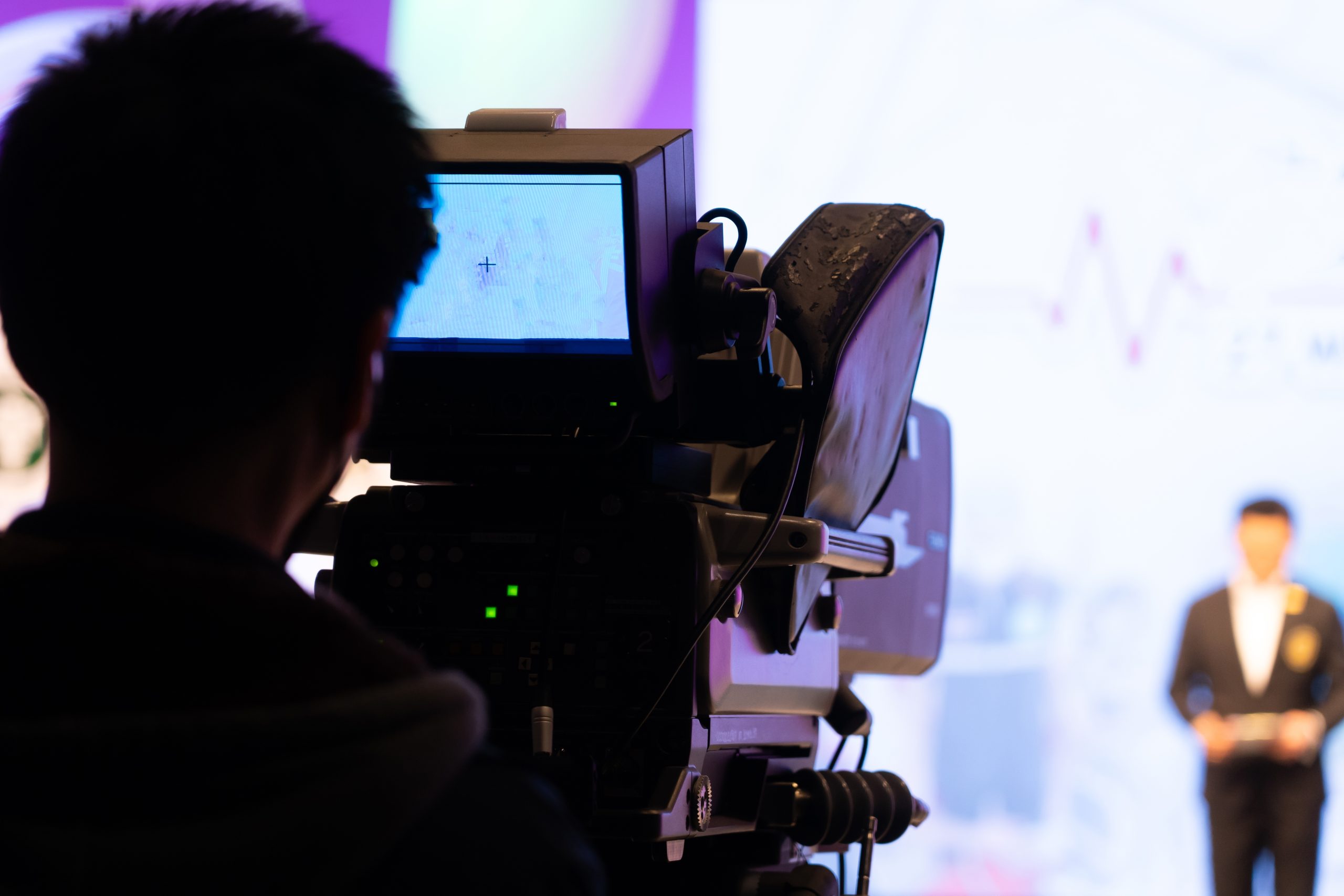 Someone pointing a camera at a presenter